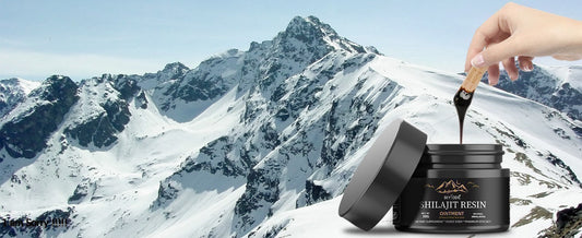 Hand pouring resin from a container against a mountainous background